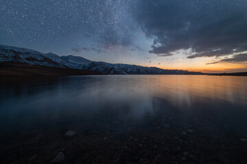 Wall Mural - beautiful night landscape. small lake and mountains in the starry night.