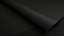 close up of a sheet of black paper with folds