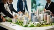 © Adobe Contributor - Business professionals discussing a city model