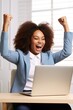 overjoyed black businesswoman celebrating success at work