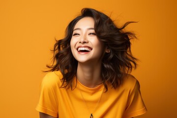 Wall Mural - Laughing woman with brown hair wearing yellow shirt