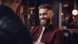 A handsome model man with a beard sitting on the chair and talks to the hairstylist barber in the hairdresser. Barbershop salon gets a new haircut trim and style it.