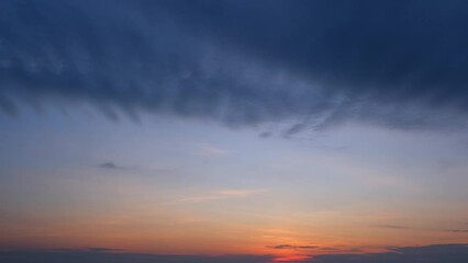 Wall Mural - A whirlwind of colors and clouds, the sky transforms in a frenetic dance, capturing the fleeting beauty of dusk. Natural movement background. Timelapse.
