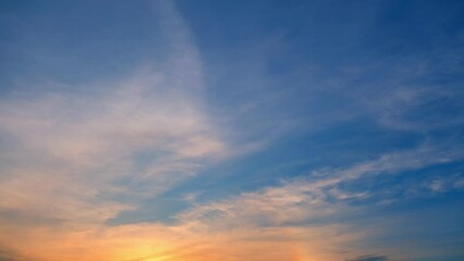 Wall Mural - The sky transforms, clouds in a hurried waltz, as the sun's farewell paints the heavens in a swift, breathtaking time-lapse of a fading day. Nature background. Timelapse.