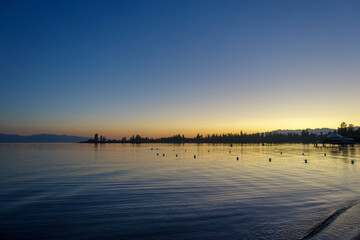 Sticker - Colorful sunset on the sea. Mountain lake in the rays of the orange sun. Kyrgyzstan, Lake Issyk-Kul. natural background