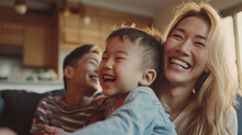 Portrait Of A Korean Family With Parents And Their Young Toddler Kid At Happy Home