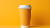 Orange paper coffee cup with white lid on orange background