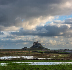 Wall Mural - Stunning dramatic landscape image of Lindisfarne, Holy Island in Northumberland England during Winter