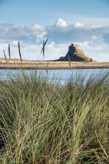 Wall Mural - Stunning dramatic landscape image of Lindisfarne, Holy Island in Northumberland England during Winter