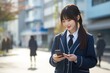 © Instacraft.Studio - Teenage student holding smartphone after school