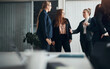 © Flamingo Images - Young businesswoman talking with two female colleagues in an office boardroom