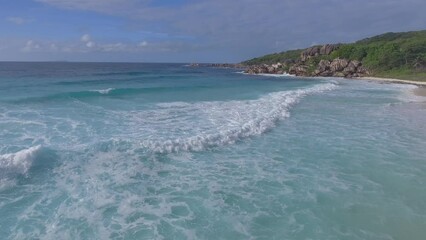 Sticker - Slow motion aerial view of small waves along the beach