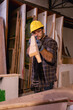 © Wanwajee - Vertical image of Young White man carpenter labor, craftman working in wood workshop together, looking follow by furniture industry.