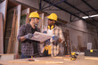 © Wanwajee - Young affrican american and white men carpenter labor, craftman working in wood workshop together. Timber industry and furniture industry small business concept.
