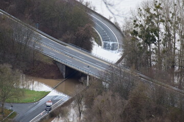 Wall Mural - Rhine flood on a county road with the main road above clear