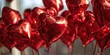 A bunch of shiny red heart shaped balloons. Perfect for Valentine's Day decorations or romantic events