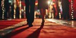 A person is seen walking down a red carpet with bright lights in the background. This image can be used to depict a glamorous event or a VIP arrival