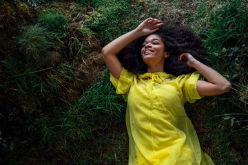 Wall Mural - Fashion and beauty shooting a charming mixed race girl in a long yellow dress