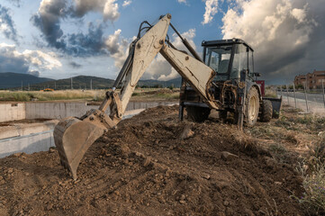 Wall Mural - Excavator at a construction site, moving earth
