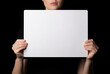 Woman Holding White Board in Front of Her Face