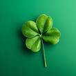 close up of single four-leafe shamrock on green background standing for as a symbol for fortune and good luck