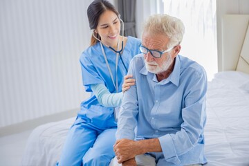 hospice nurse is using stethoscope on caucasian man in bed for diagnosing lung cancer and heart rate