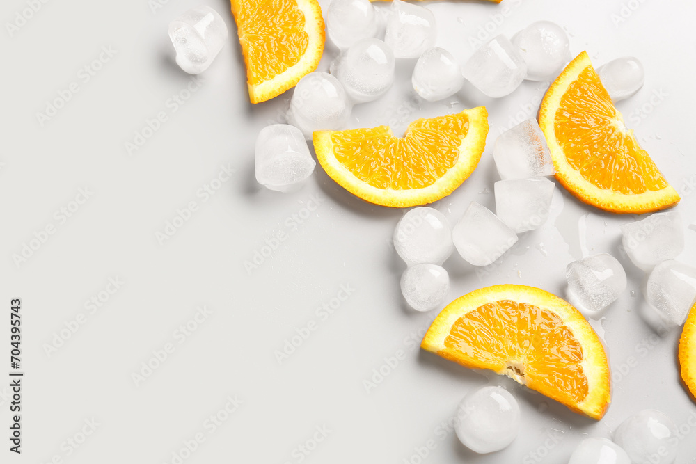 Orange slices with ice cubes on white background
