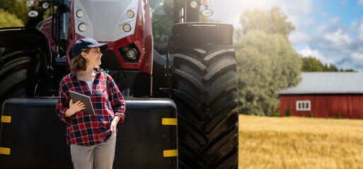 Aufkleber - Woman farmer with a digital tablet on the background of an agricultural tractor