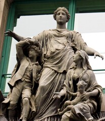 Wall Mural - Vienna. Austria. March 15, 2019. Sculpture of a man talking to an angel in the square of the Austrian capital.