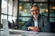 © FrameFlow - Smiling mature business man of middle age, confident entrepreneur or bank manager, 50 years old executive, mid aged businessman investor trader, male lawyer sitting at work desk, Generative AI