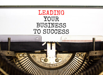 Wall Mural - Leading your business to success symbol. Concept words Leading your business to success typed on old retro typewriter. Beautiful white background. Leading your business to success concept. Copy space