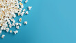 popcorn scattered on blue background. copy space for text