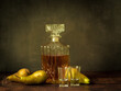Antique-style still life with pears and alcohol whiskey.