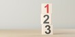 © Shawn Hempel - Numbers one, two and three on wooden blocks standing on table, plan, priority or winner business concept