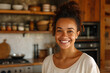 Close-up shot of a smiling woman standing in a kitchen. Natural soft light and wood color tones.