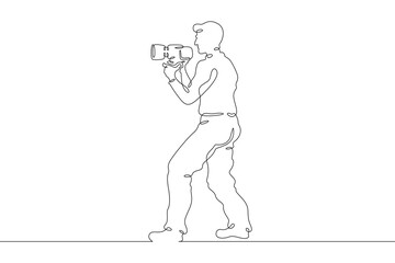 Wall Mural - Photographer on the set. Photographer with a camera in his hands. The cameraman is filming. One continuous line drawing. Linear. Hand drawn, white background. One line