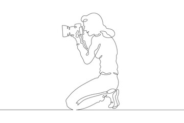 Wall Mural - Photographer on the set. Photographer with a camera in his hands. The cameraman is filming. One continuous line drawing. Linear. Hand drawn, white background. One line