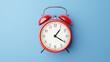 © ruangrit19 - Red vintage alarm clock on light blue color background,3D render