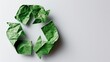 Recycling symbol from crumpled green paper on a white background