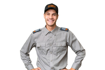 Wall Mural - Young security man over isolated background posing with arms at hip and smiling