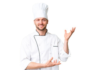 Wall Mural - Young caucasian chef over isolated chroma key background extending hands to the side for inviting to come