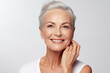 © Darya Lavinskaya - Gorgeous senior older Caucasian woman with short silver hair and natural makeup touching her face