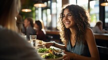 Smiling Woman Eating Salad In Restaurant