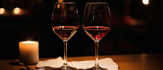 Two glasses of red wine on a table in a restaurant. .