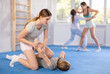 Pair self-defense training - two teenage girls doing power grabs