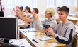© JackF - Teen students using smartphones to find necessary information on lecture in college class