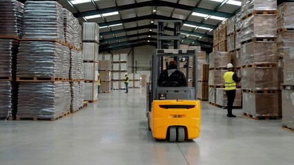 Canvas Print - Full team of warehouse employees walking in warehouse. Team of workers, managers, female director in modern industrial factory, heavy industry, manufactrury.