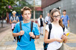© JackF - Young students with backpacks and notebooks walk down the street