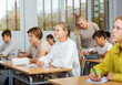 © JackF - Group of diligent school kids and teacher during lesson in classroom in secondary school