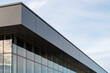 © Dolores  Harvey - The exterior wall of a contemporary commercial style building with aluminum metal composite panels and glass windows. The futuristic building has engineered diagonal cladding steel frame panels.